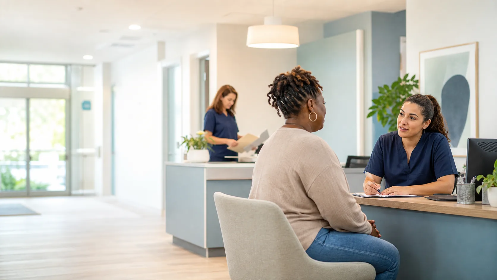 Healthcare staff member helping a patient learn about services at a Pomona community health center