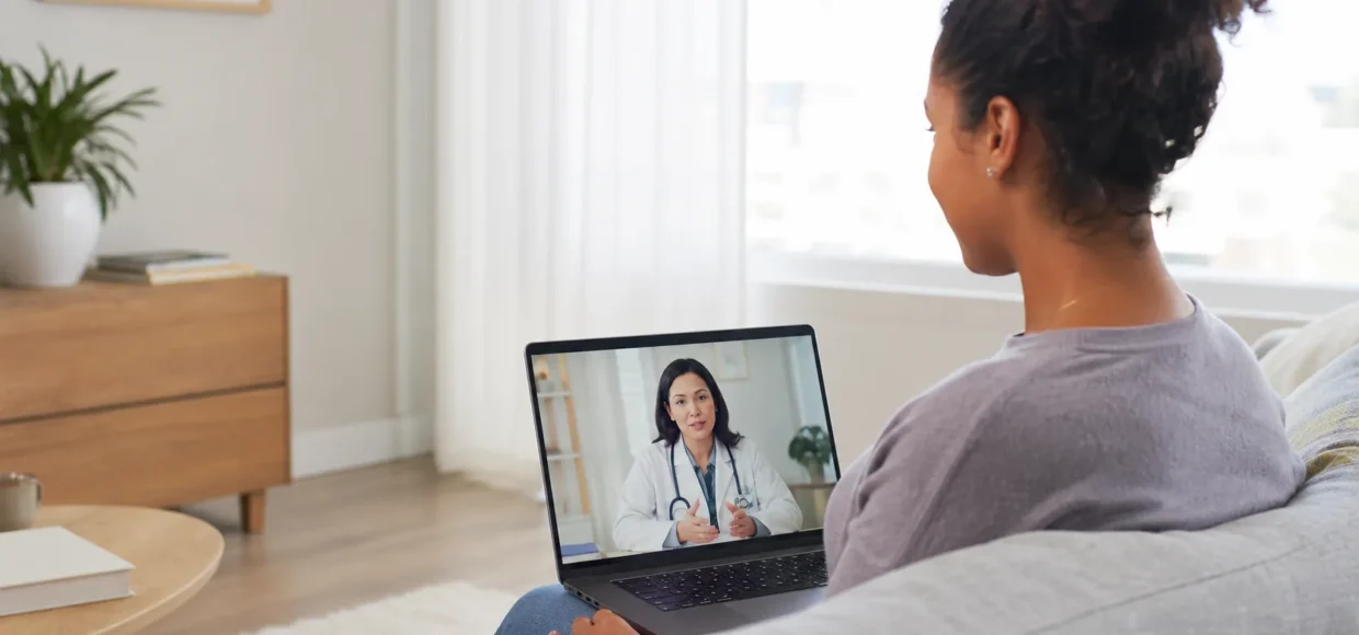 Patient using a laptop for a telehealth visit with a community health provider