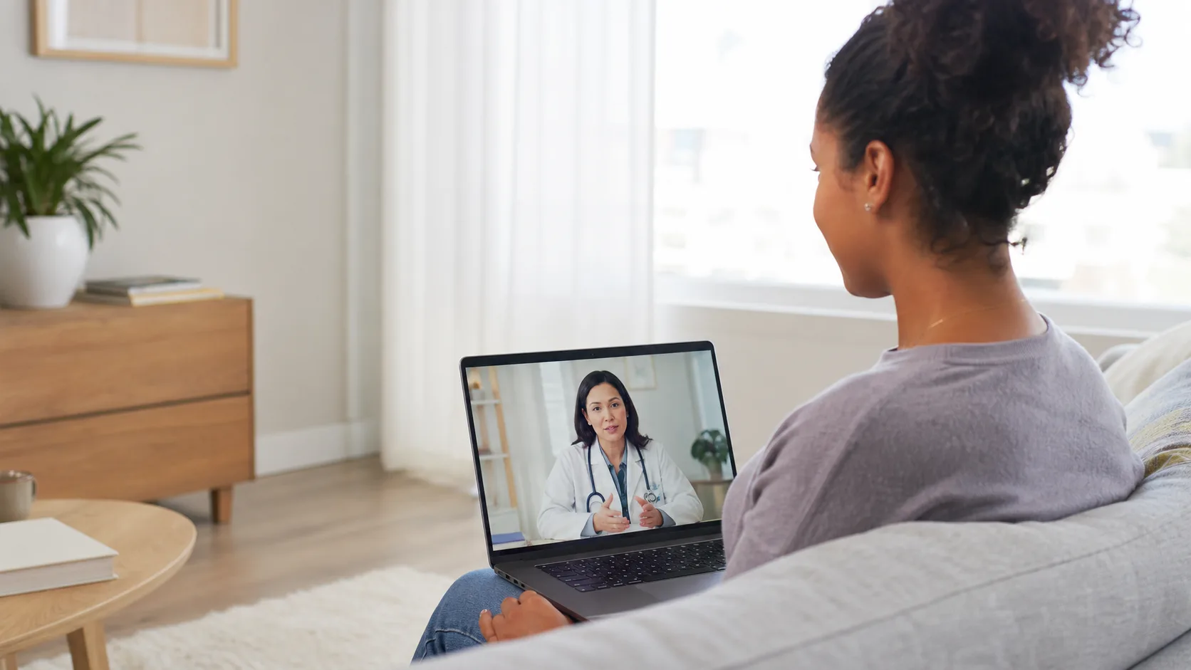 Patient using a laptop for a telehealth visit with a community health provider